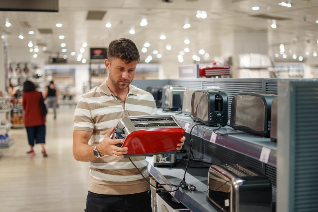 Man selecting toaster in mall