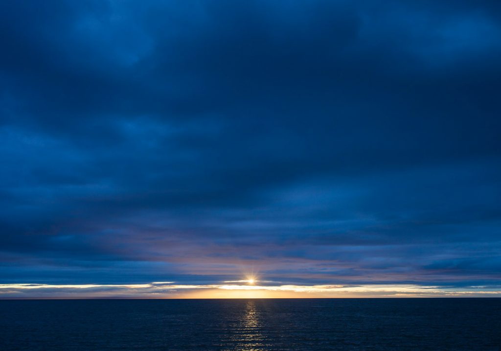 Sunset over Ocean on a Dark Cloudy Morning