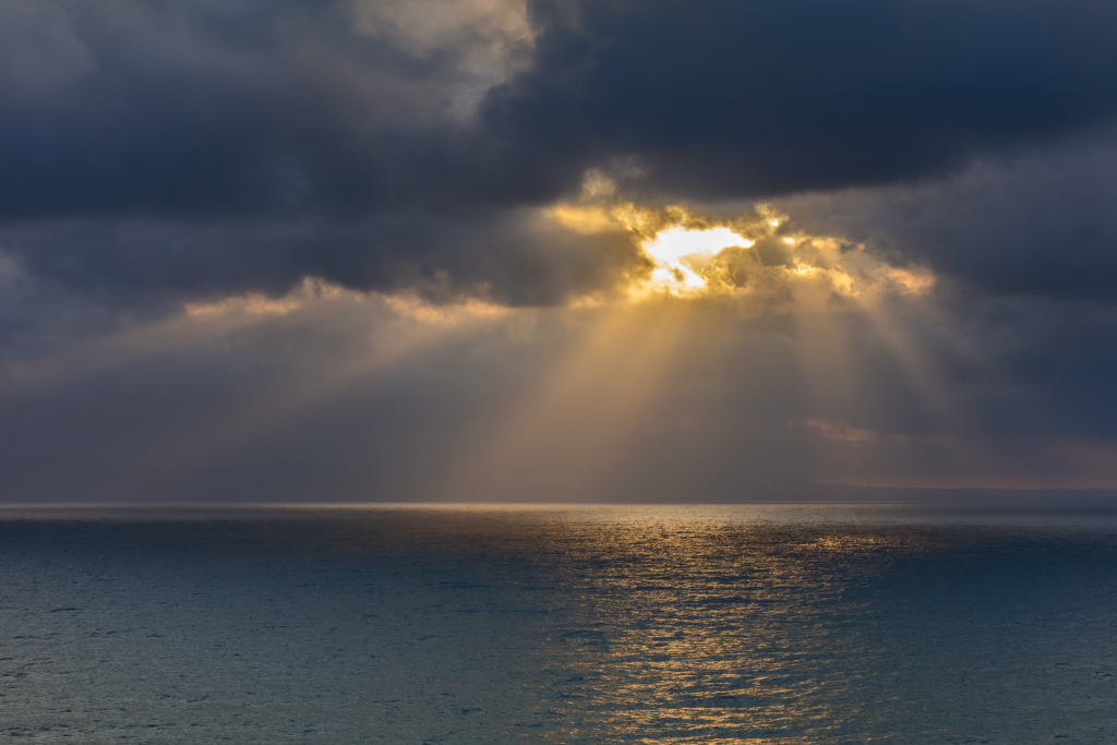 sunrise breaking through the dark clouds